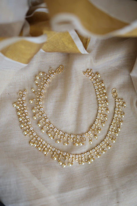Heritage gold white stone and pearl traditional payal AN12155